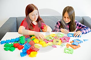 Two girls playing lego