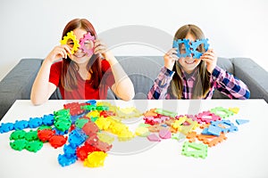 Two girls playing lego