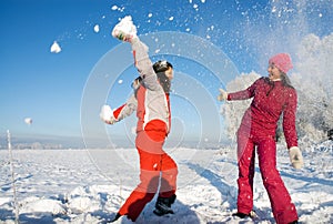 Two girls playing with snow