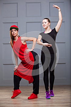 Two girls in the pose of the beginning of the dance. The concept of employment of the Chancellor.