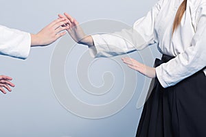 Two girls practice Aikido on martial arts training