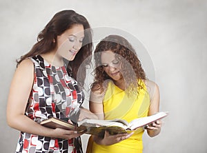 Two girls read book