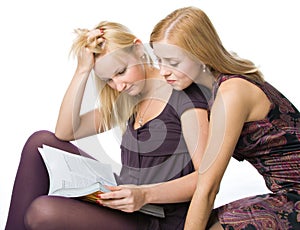 Two girls reading magazine