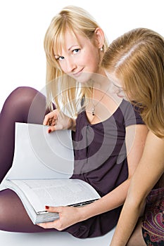 Two girls reading magazine