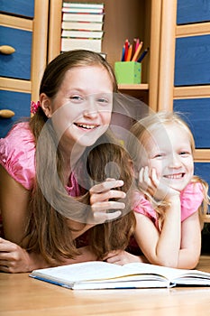 Two girls reads book