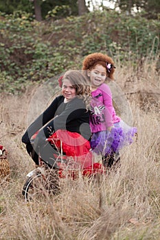 Two girls riding a bike