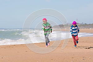 Two girls running on beach seaside