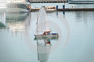 Two girls are sailing on a small sailing boat