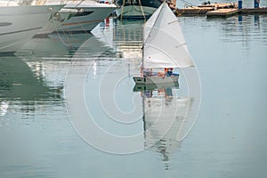 Two girls are sailing on a small sailing boat