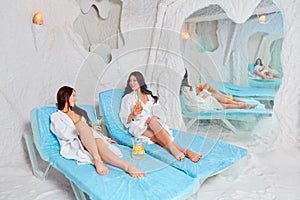 Two girls in the salt room. Halotherapy for recovery.Place for text