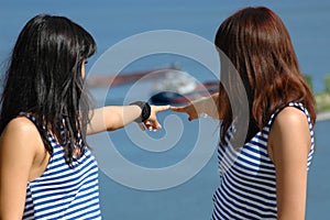 Two girls show hand on nave photo