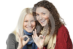 Two girls showing OK signs