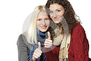 Two girls showing thumb up signs