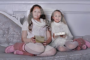 Two girls sister with gifts in hands