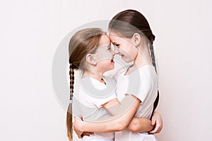 Two girls sisters gently hug each other when meeting