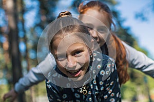 Two girls sisters or girlfriends having fun outdoors.