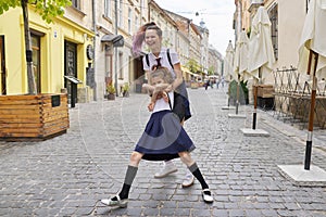 Two girls sisters having fun on the way to school