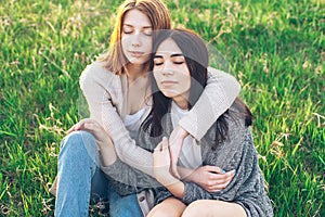 Two girls sitting on the grass