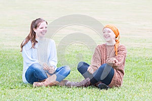 Two Girls Sitting on Grass