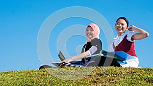 Two girls study happily