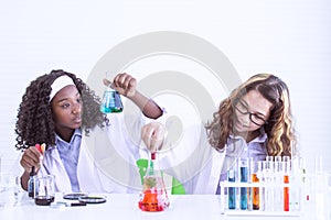 Two girls studying science in classroom at school