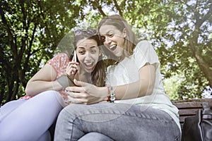 Two girls surprise social media unexpected youth millennial friendship media concept addiction to new technology trends lifestyle