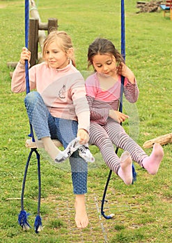 Two girls on swing