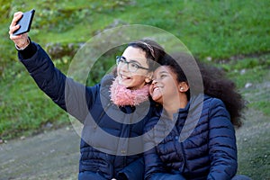 Two girls taking a photo with the mobile