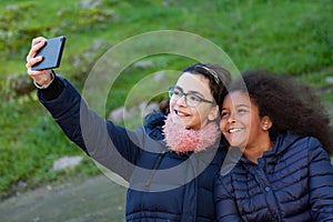 Two girls taking a photo with the mobile