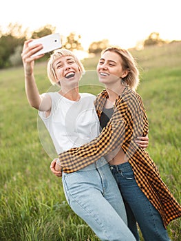 Two girls taking selfie outdoors photo