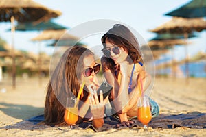 Two girls taking selfy on a beach