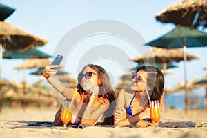 Two girls taking selfy on a beach