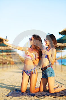 Two girls taking selfy on a beach