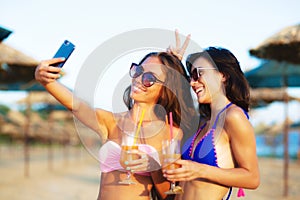 Two girls taking selfy on a beach