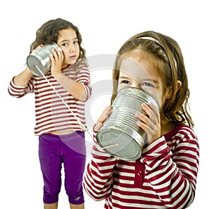 Two girls talking on a tin phone