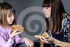 Two girls tasting food