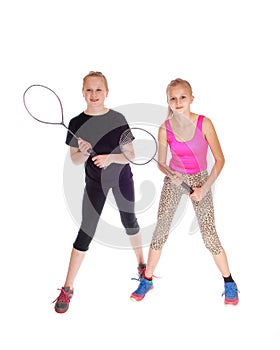 Two girls with tennis racquet.