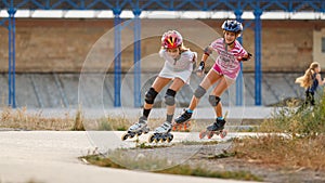 Two girls training in speed skating on rollerdrome