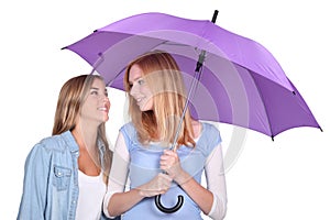 Two girls under an umbrella