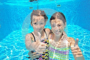 Two girls underwater in swimming pool