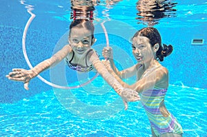 Two girls underwater in swimming pool