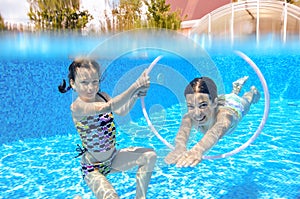 Two girls underwater in swimming pool