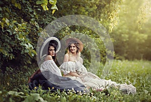 Two girls in vintage clothes and hats