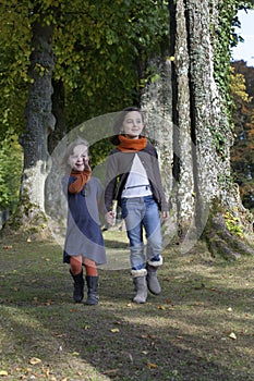 Two girls walking on a path in the wood