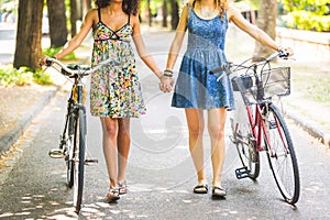 Two girls walking on the street holding hands