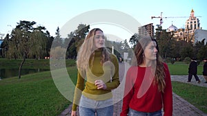 Two girls walking and talking at park in Batumi