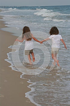 Two Girls walking in the water