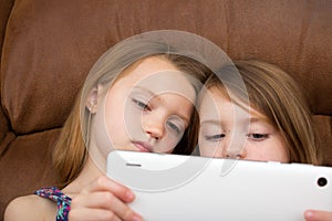 Two girls watching a tablet together