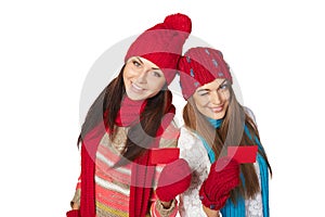 Two girls in winter clothing showing credit cards