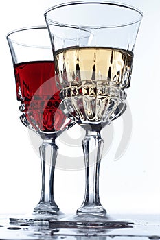 Two glases with white and red wine on a table